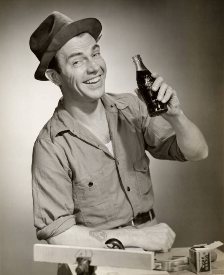 Smiling carpenter with his Coca-Cola